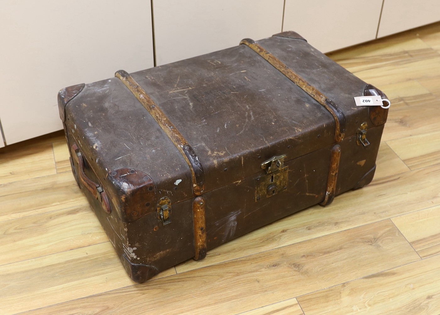 A trunk of various collectables including a Japanese carved wood bear, mounted antlers, other carvings etc.